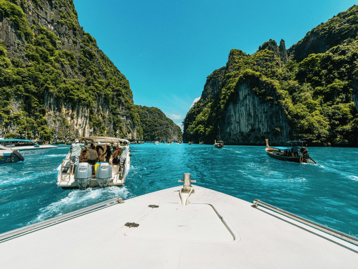 Boat trip through turquoise waters surrounded by limestone cliffs.