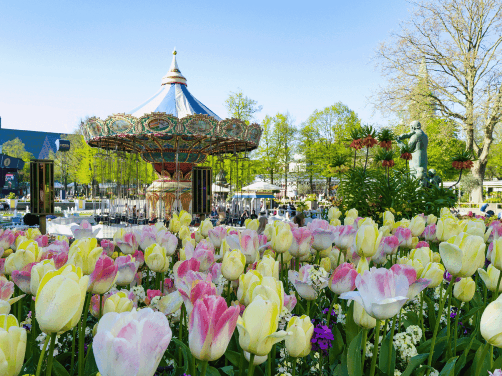 Carousel surrounded by spring flowers at Tivoli Gardens in Copenhagen.