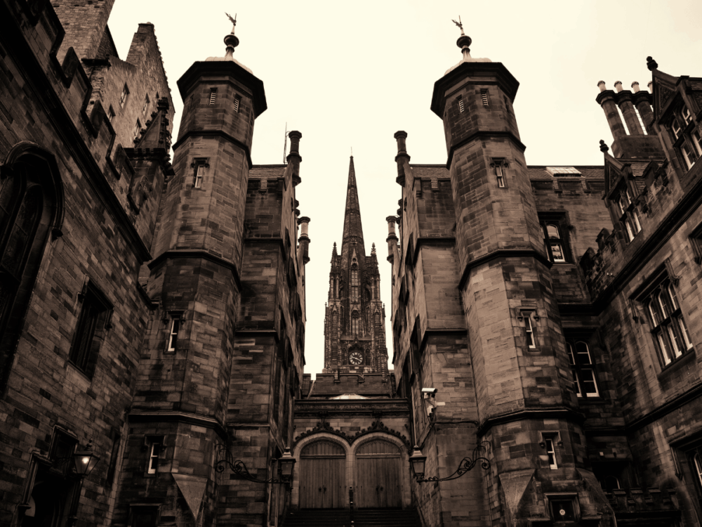 Historic stone buildings and church spire on a ghost tour route