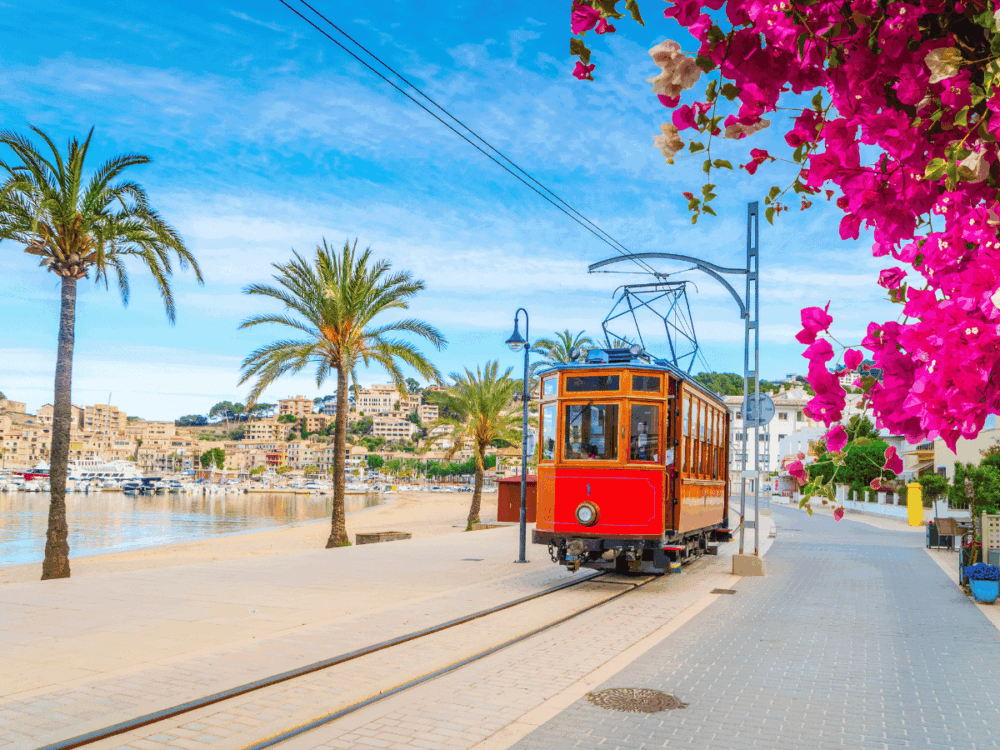 Vintage tram travelling along the waterfront in Port de Sóller, Mallorca.