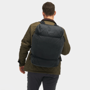 Rear view of a person wearing the black Gomatic Navigator Collapsible Duffle 42L as a backpack.