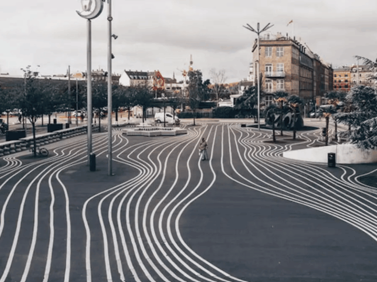 Curved white lines across the pavement at Superkilen Park in Copenhagen.