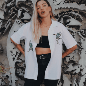 Woman modelling the white Broken Society Cranes Havana Shirt with embroidered crane designs