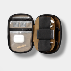 Open McKinnon Tech Organiser holding cables and small tech accessories in transparent pockets, elastic sections and internal compartments.