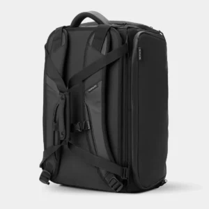 Rear angled view of the black bag showing its shoulder straps and fastening strap