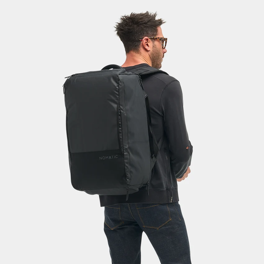 Person wearing the black bag as a backpack, viewed from behind