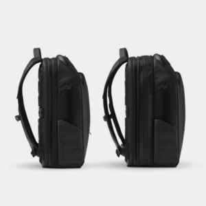 Side-by-side side views of the black Nomatic Travel Pack showing its collapsed and expanded depths.