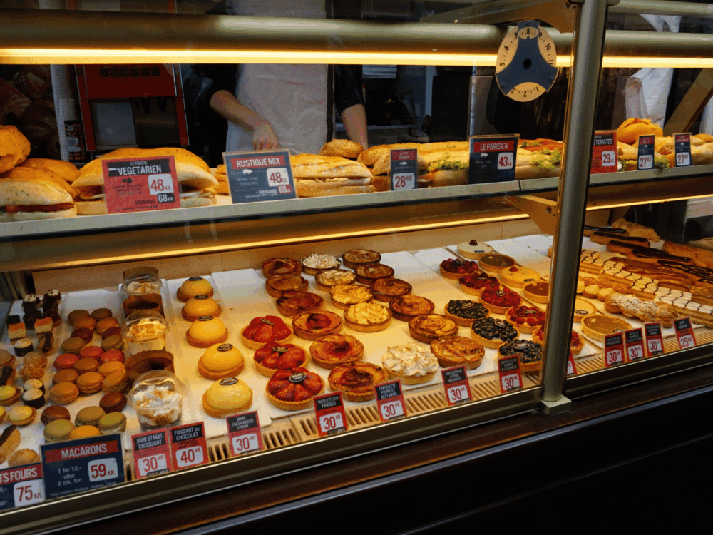 A bakery display filled with assorted pastries and sweet treats.