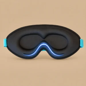 Black contoured sleep mask shown from the inside, with raised eye areas, turquoise strap ends and a blue curved line near the nose.